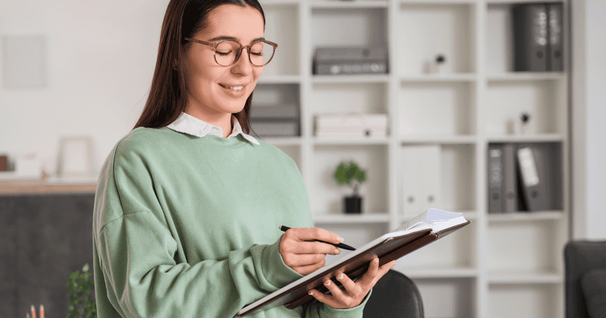 woman reading and writing a report 
