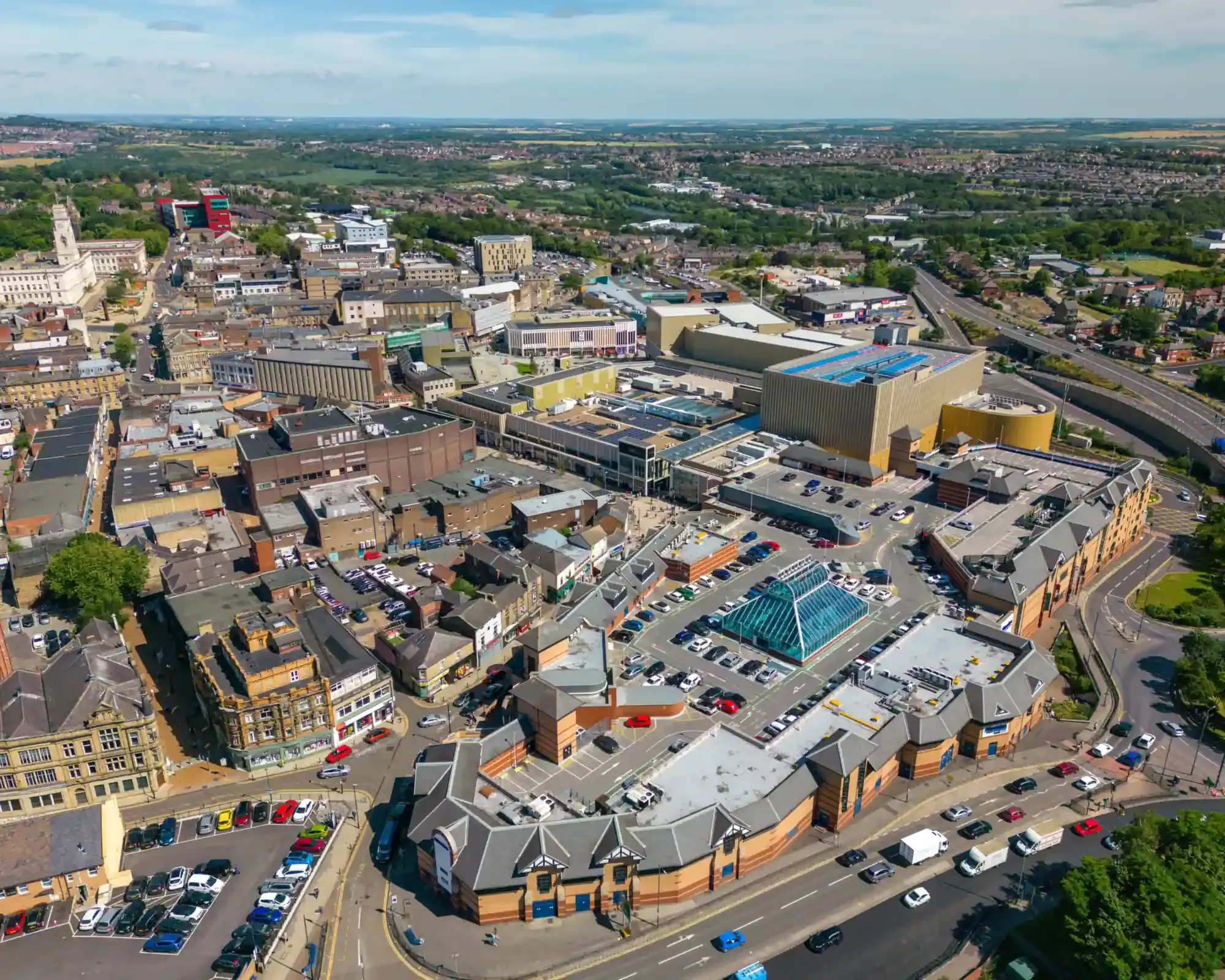 Aerial view of Barnsley town centre showing the Glass Works and Alhambra shopping centre, with the Town Hall tower in the distance.
