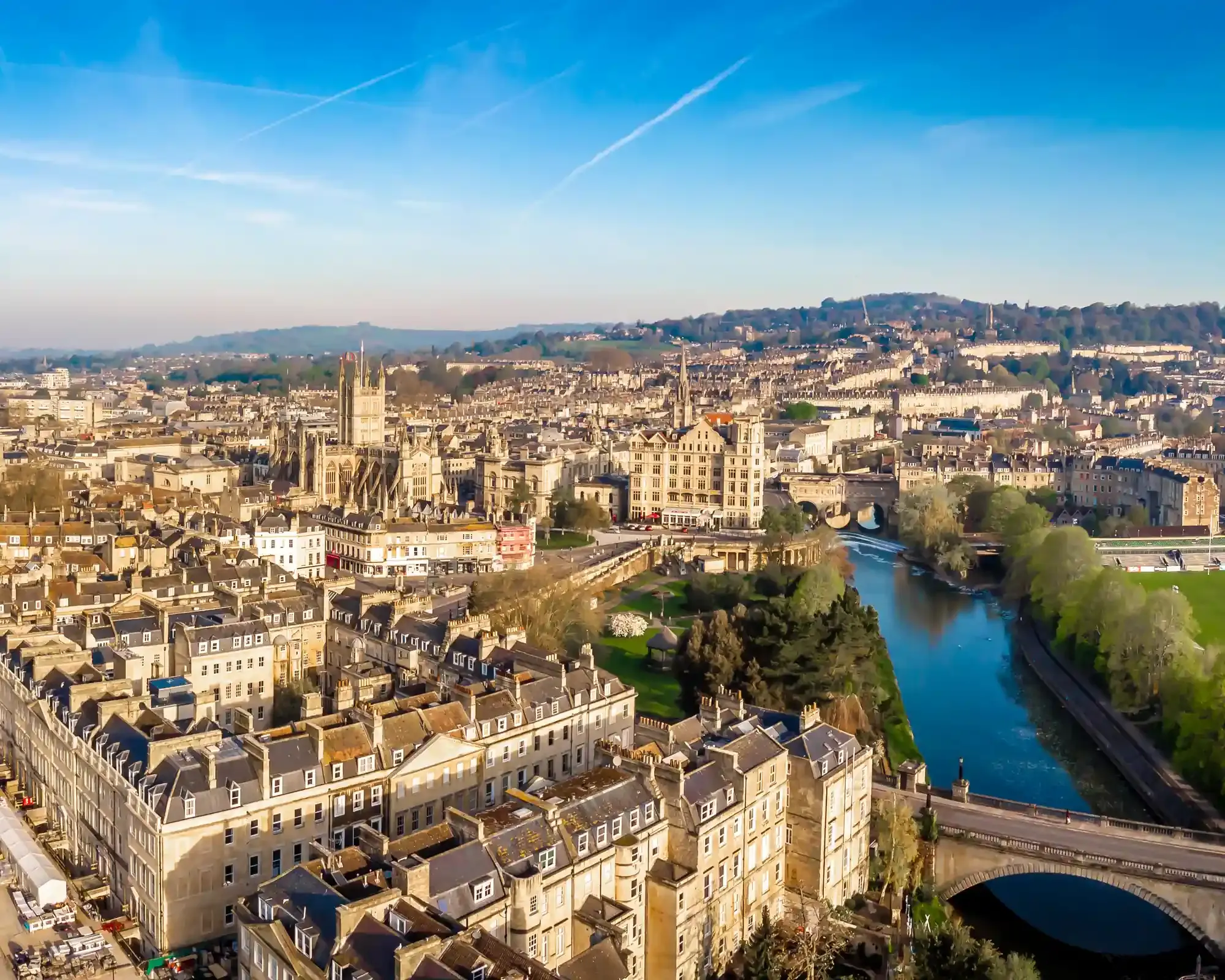 Aerial view of Bath city centre with Bath Abbey, Georgian terraces and Pulteney Bridge over the River Avon.