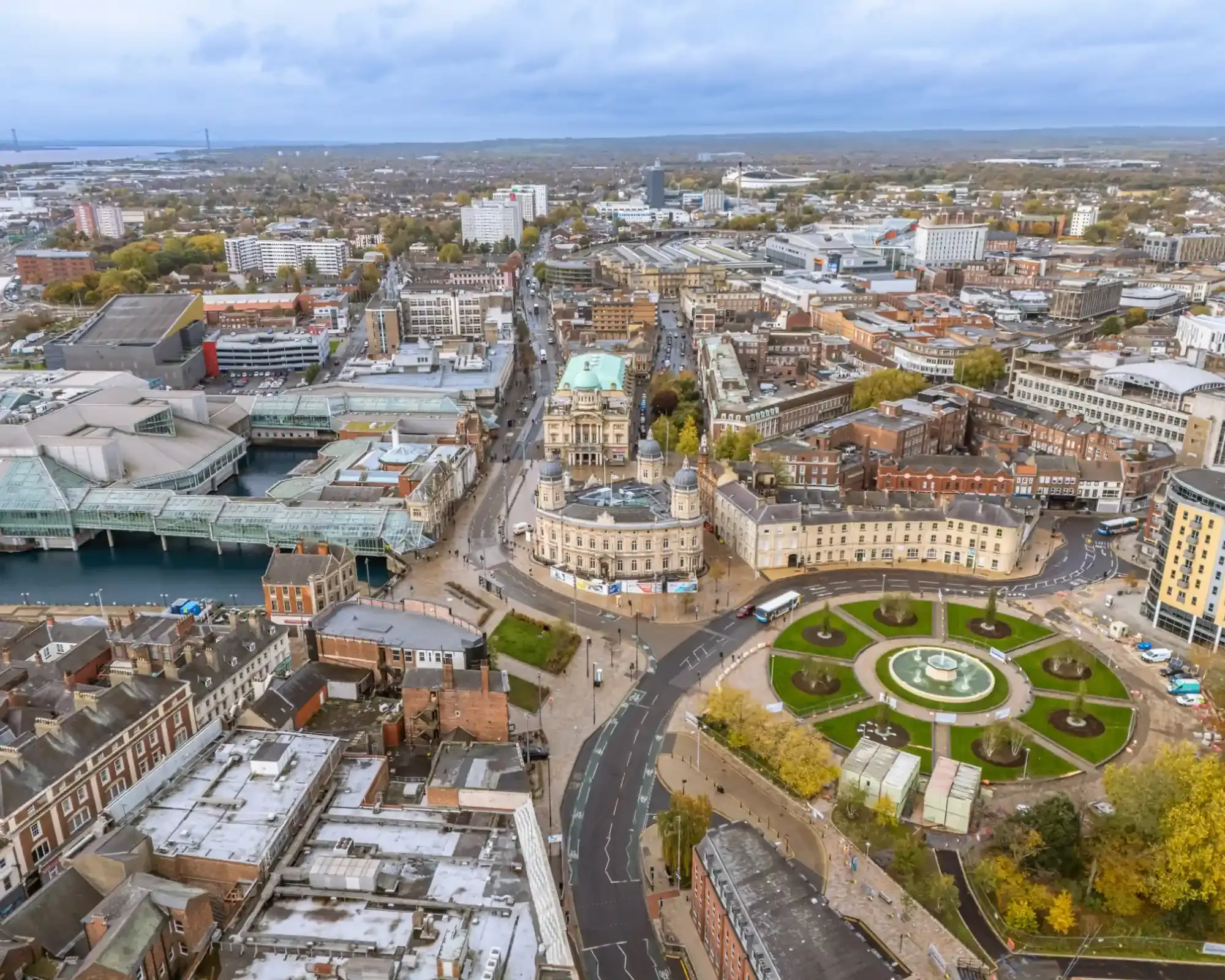 Aerial view of Hull city centre with Queen Victoria Square, the Maritime Museum and Princes Quay, and the Humber Bridge in the distance.