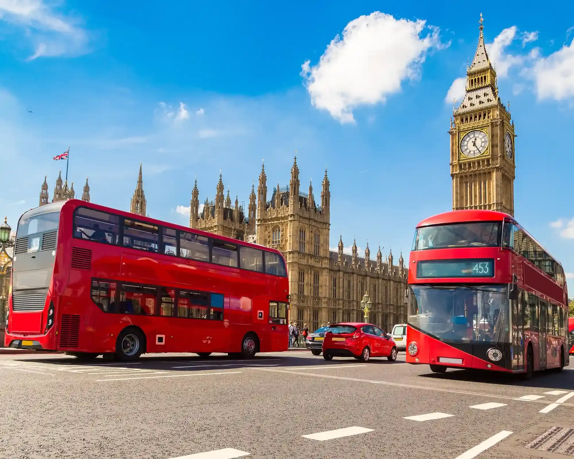 Big Ben and the Houses of Parliament in London, with red double-decker buses, home to our conveyancing solicitors