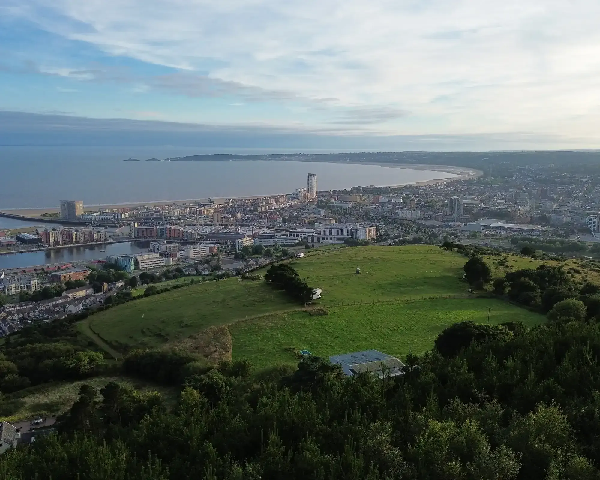 Aerial view of Swansea Bay and the city skyline, featuring Swansea beach and Meridian Tower