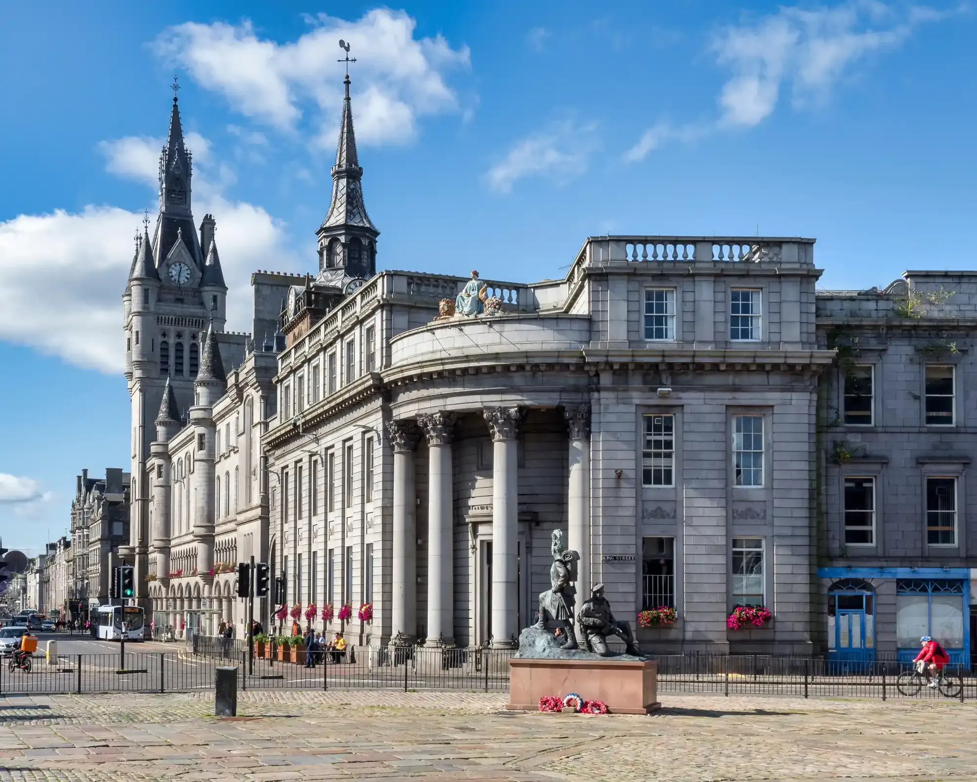 Granite buildings on Castlegate in Aberdeen, with the Town House tower and the Gordon Highlanders statue.
