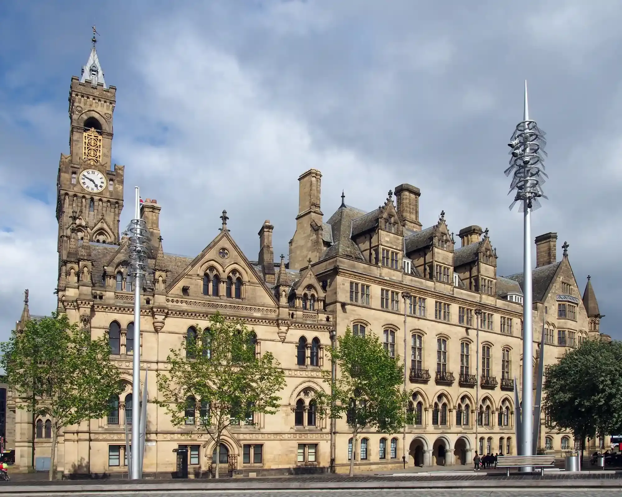 Bradford City Hall’s Gothic sandstone front and clock tower against a cloudy sky.