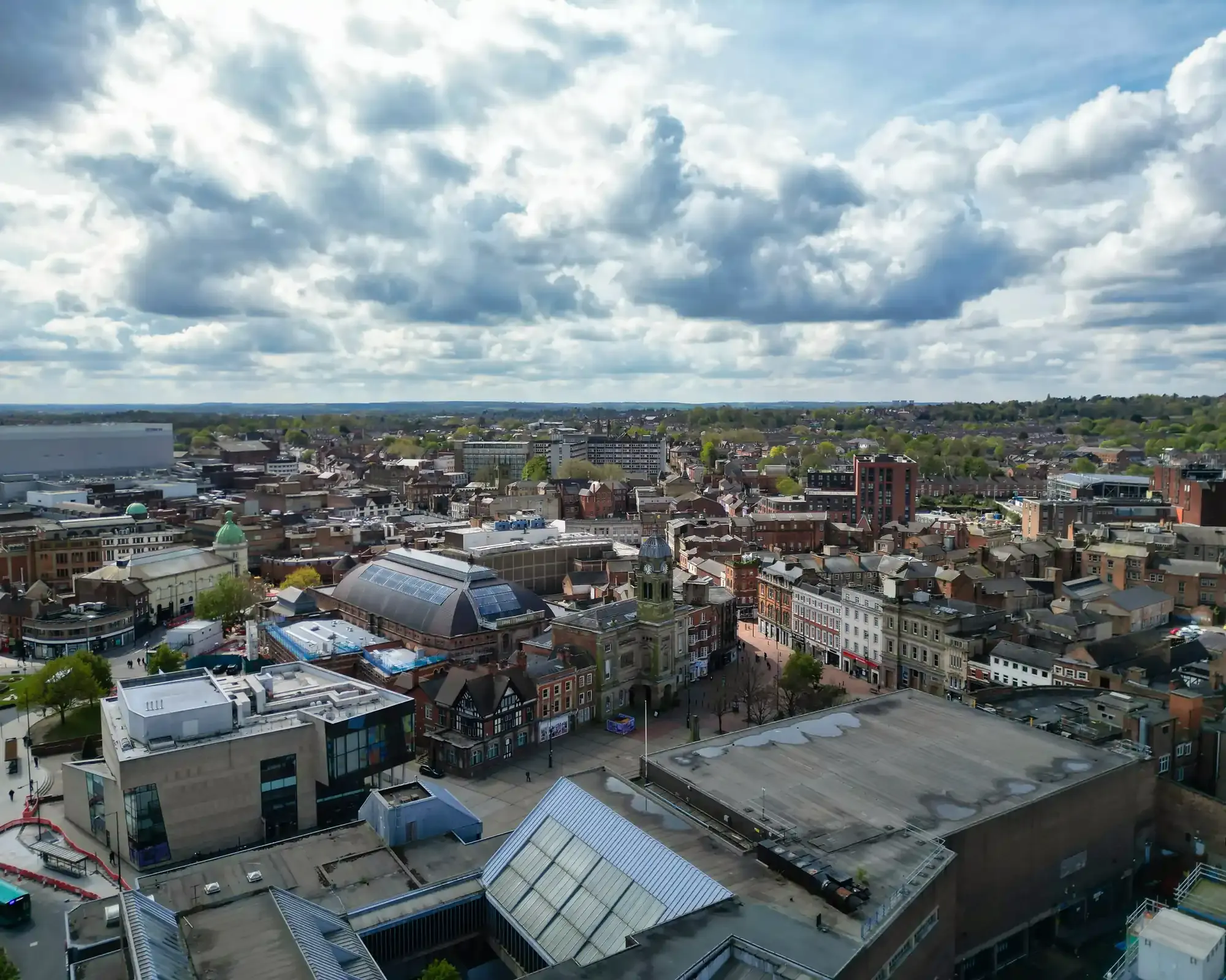 Aerial view of Derby city centre, showing the Guildhall clock tower and the Market Hall roof.