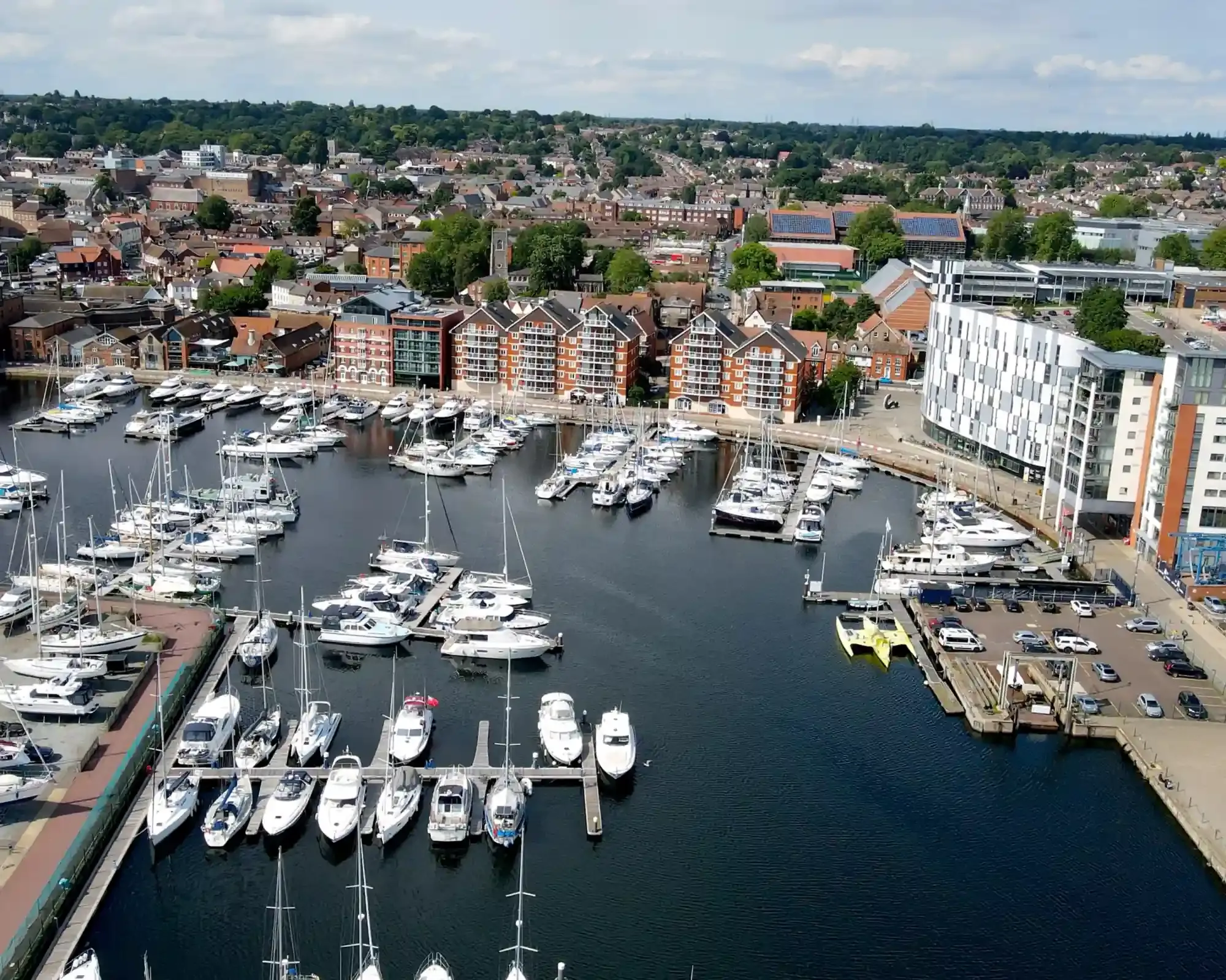 Aerial view of Ipswich Waterfront, with boats in the marina and the town centre behind.