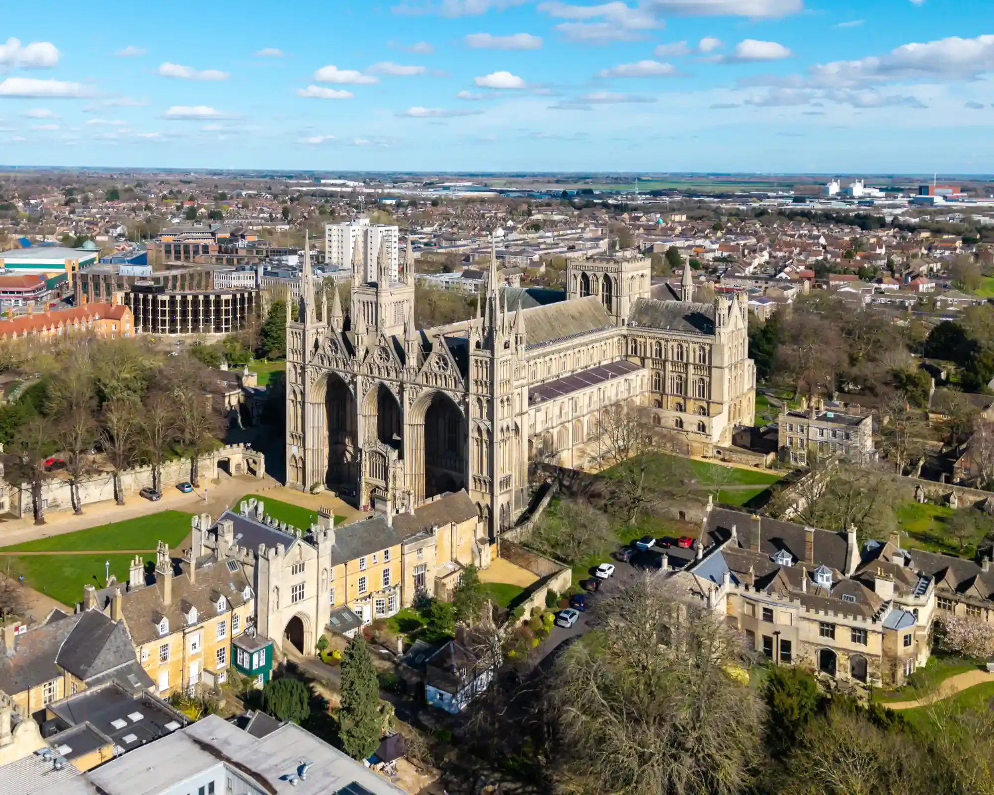 Aerial view of Peterborough Cathedral and its precincts, with the city stretching out behind.